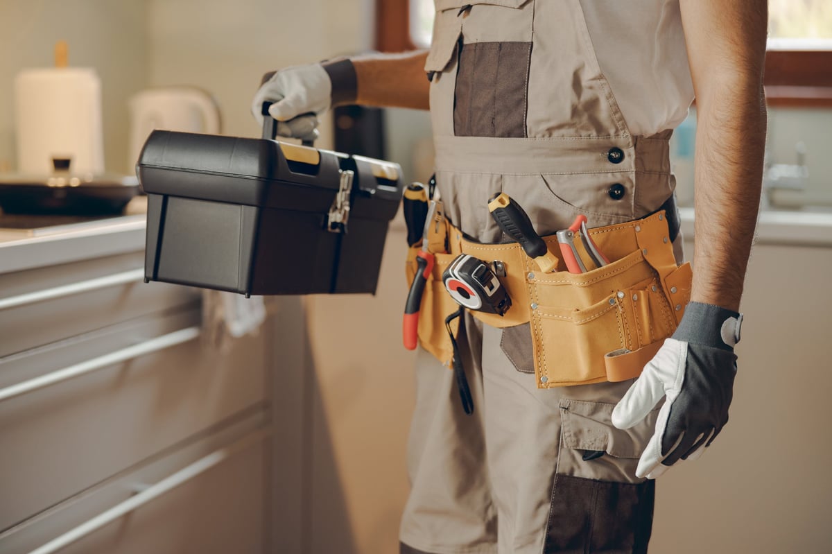 Professional handyman holding his tool bag