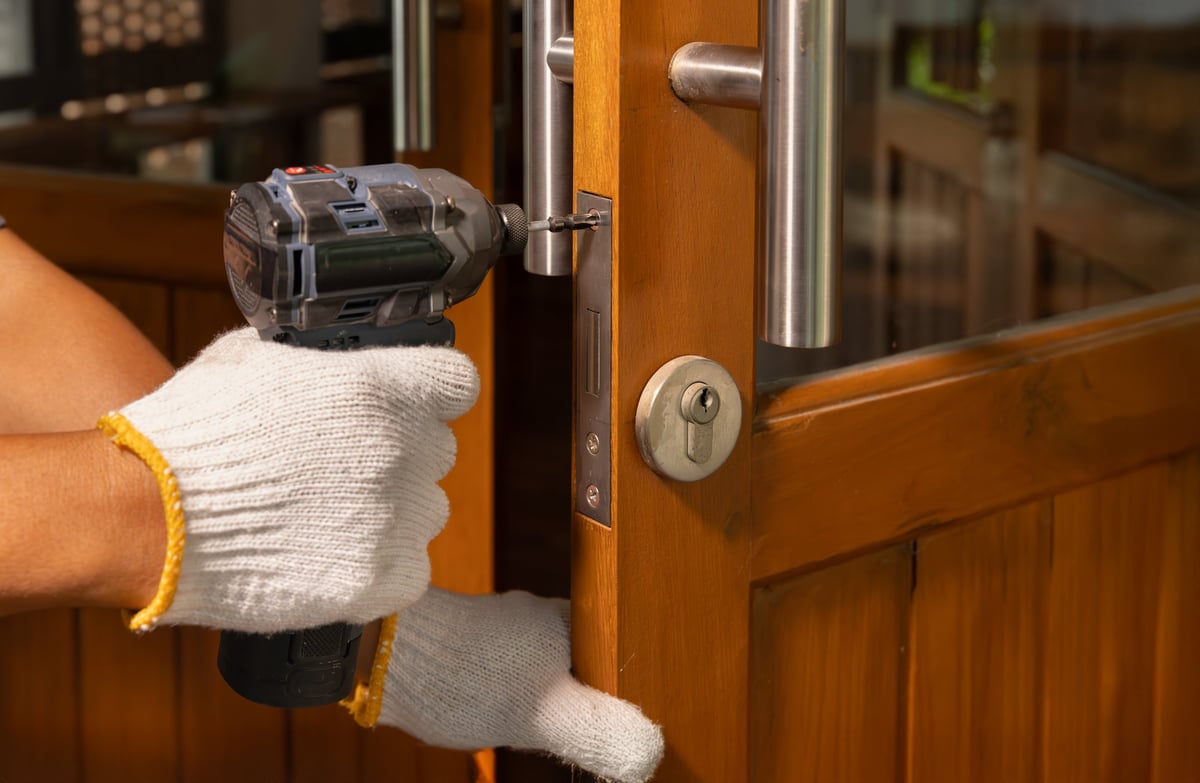 Locksmith fixing lock door