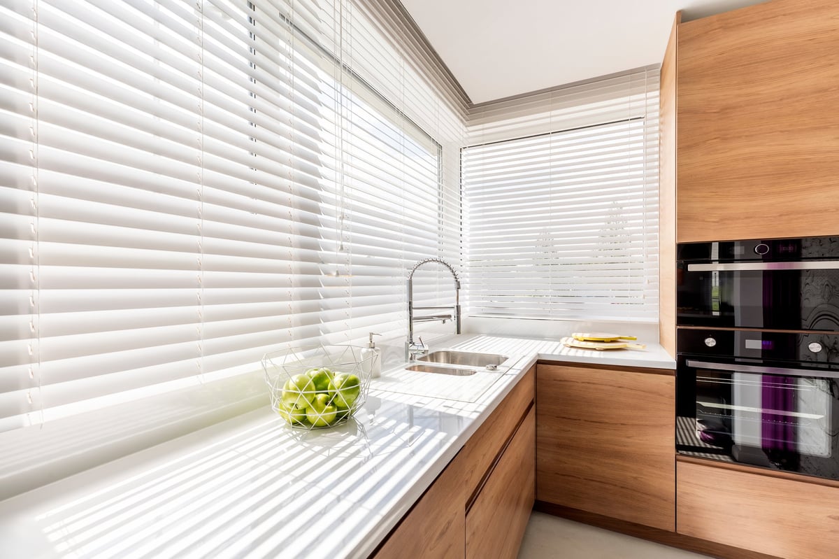 Modern kitchen interior with white horizontal window blinds